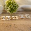 Set x3 Pares de Aretes CH en Oro Laminado 18k – Elegancia Versátil para Cada Día.